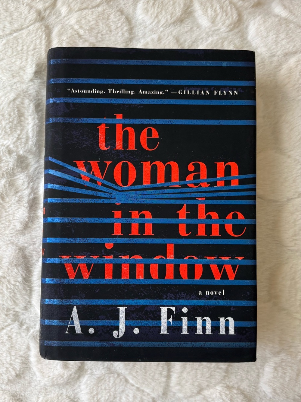 The Woman in the Window by A. J. Finn - Black with Red & Blue Cover